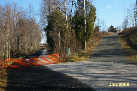 Turn right after crossing the bridge to climb the hill. The trail to the left is not completed yet.