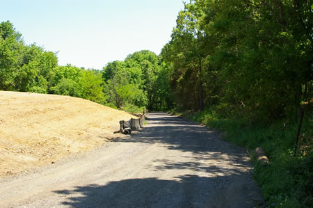 After a very short distance turn right to follow a hard surface trail .