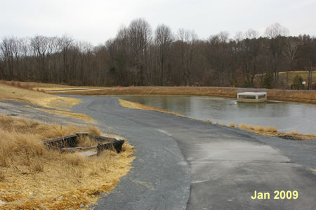 Stay straight on the asphalt trai l as it passes next to the retention basin.