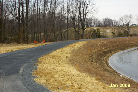 The trail turns right at the end of the retention basin.