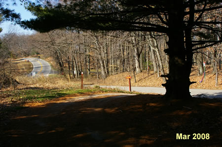 Turn left and walk down the hill on the restricted road.