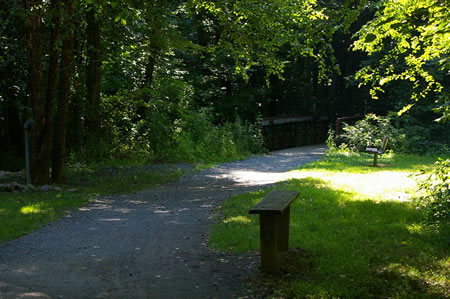 The trail crosses a bridge over Bear Branch. There are private tennis courts just prior to the bridge.