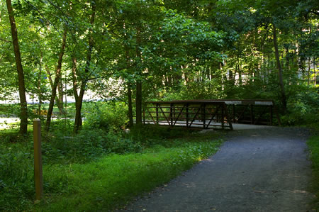 The trail crosses a bridge over Bear Branch. Notice the private tennis courts just beyond the bridge.