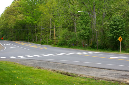 Use the crosswalk to cross Vale Rd. and turn left on the other side to walk a short distance along the edge of that road.