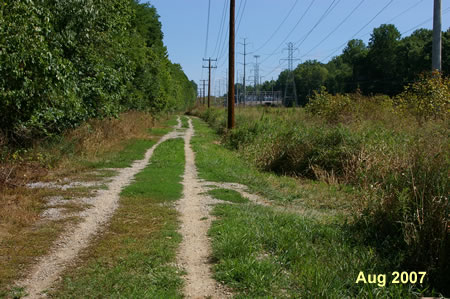 The trail follows vehicle tracks along the power lines.