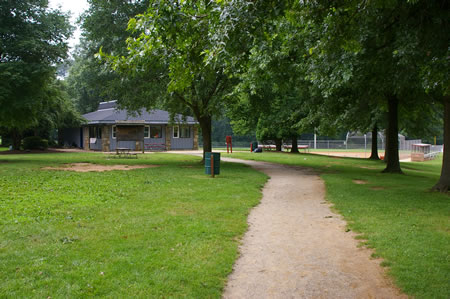 Follow the trail to the front of a building near the ballfields. turn left and follow the sidewalk towards the back of that building. There are restrooms on the back side.