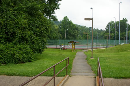 Turn left onto the trail at the first light pole after crossing the bridge.