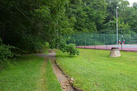 The trail passes along the side of the tennis courts.