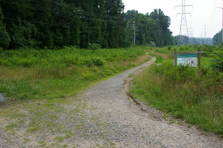 The trail to the right passes a sign marked Project Habitat.
