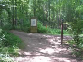 At the next trail intersection there are several signs and a map.  Turn left to follow the trail up the hill.