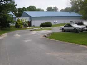 The Indoor Tennis Facility will be on your right as you cross the parking lot.