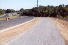 Turn right and walk along the gravel path (may be paved) along the Fairfax County Parkway.