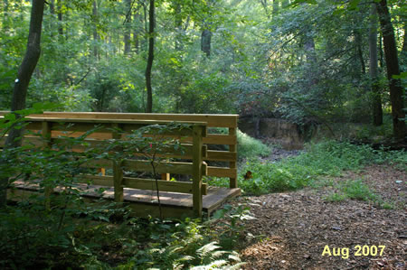 Turn left at the next path and use the bridge to cross the stream.