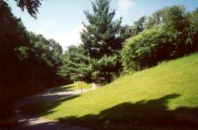 Follow the asphalt path towards the back of the school on the east side of the school.