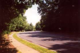 The path reaches a sidewalk along Soapstone Dr.  Turn left along the sidewalk.