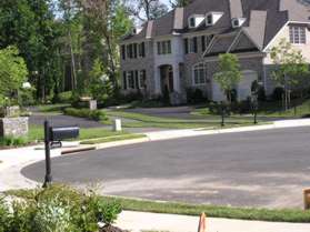 Turn left onto the sidewalk and walk around to the asphalt trail between 1113 and 1114.