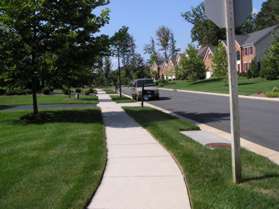 Turn left to follow the sidewalk along Turnwell Stable Ct.