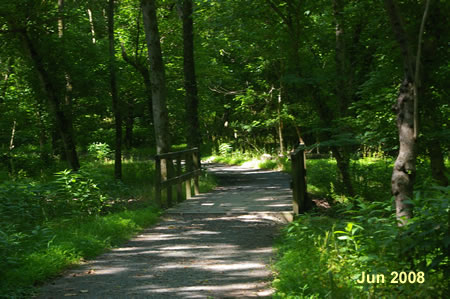 The trail crosses a bridge over the canal bed.