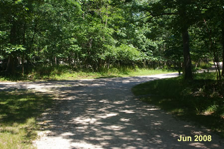 A trail intersects from the left.  Keep on the present trail to the right.