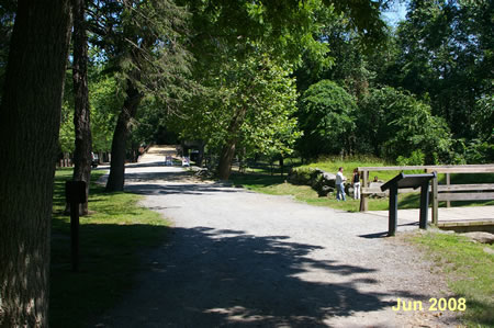 A trail crosses a bridge on the right.  Keep straight on the present trail to the visitor center.