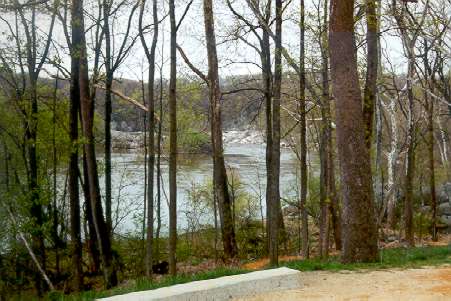 The Potomac River can be seen below through the trees.