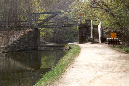 Stay on the towpath past the trail to the overlook until you come to the bridge.  Cross the canal on the bridge.