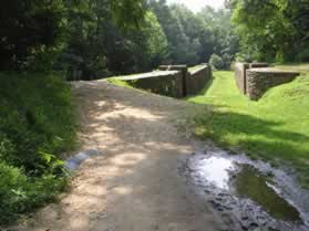 The trail splits prior to lock 1. Take the trail to the left over the canal bed.  The trail to the right is overgrown in places.