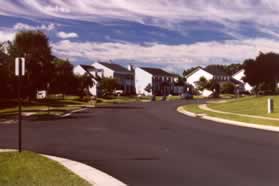 After intersecting with Kingstream Circle Kingstream Dr starts to turn to the right.  Continue on the sidewalk along Kingstream Dr.