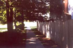 The asphalt path ends, turn right and follow the sidewalk to Huntsman Pl.