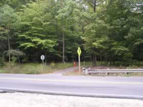 Cross Hooes Rd to go east on the asphalt trail across from the service road to Lake Mercer.