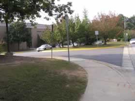 The sidewalk passes in front of the entrance to Newington Forest School.