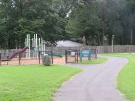 The trail passes by a tot lot on the left.