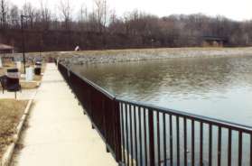 Follow the sidewalk from the front of the marina office to the entrance road leading under the railroad bridge.