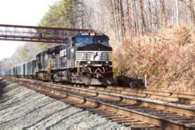 A Norfolk Southern freight passes under the bridge to Carrleigh Pkwy.