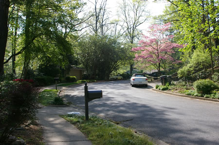 The trail emerges on a cul-de-sac.  Follow the sidewalk on the left to the other end of South Shore Rd.