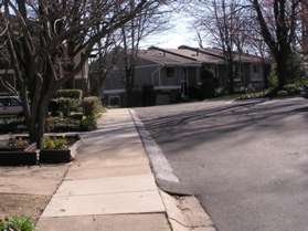 After passing the homes on the left another group of homes appears on the left.  Turn left to follow the sidewalk in front of those homes.