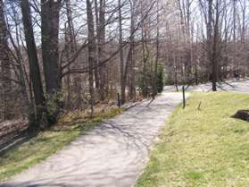 At the top of the steps turn right and follow the asphalt trail along the side of the parking area.