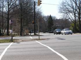 The trail crosses Baron Cameron Av. in the crosswalk.  There is a walk light here.