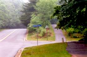 The trail returns to Glade Dr and shortly crosses Quartermaster Ln.