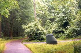 Take the path to the right at the manhole painted green.