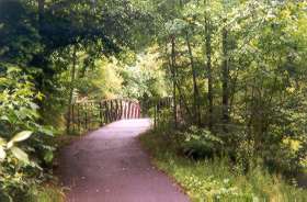 The trail crosses a bridge over the creek.