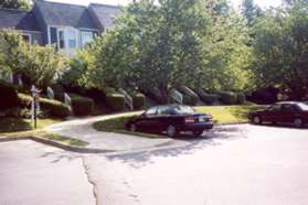 The trail crosses Silentwood Ln.  On the other side it follows a sidewalk to the right in front of the homes pictured, then turns left between houses.