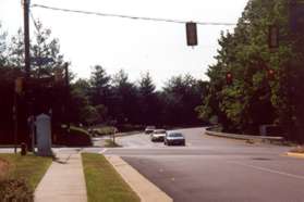 Cross a second entrance road to the center and turn right onto the sidewalk on the other side.  Cross South Lakes Dr at the traffic light shown.