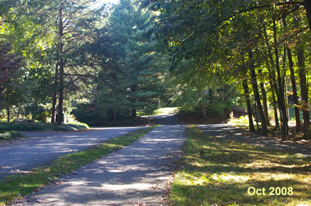 The trail passes between 2 driveways ending at Owls Cove La.