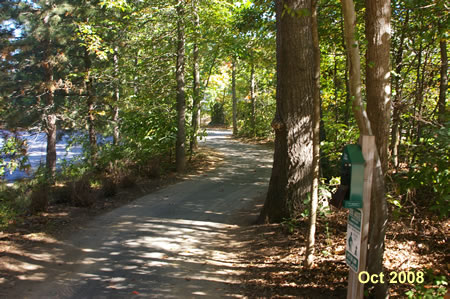 Turn right and follow the first asphalt trail on the right down the hill. A driveway to a school parking area should be on your left.