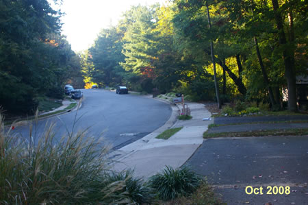 The asphalt trail turns to the right. Continue straight on the concrete sidewalk along Owls Cove La.