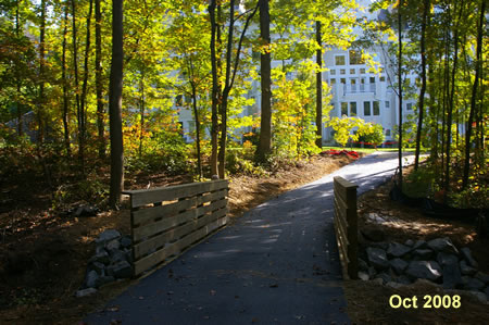 The trail crosses a bridge over a side stream.