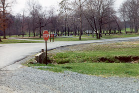 At the stop sign turn right along the paved road.