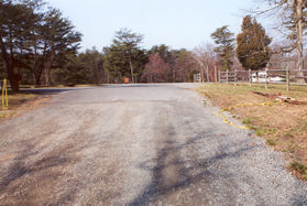 The road intersects with other roads at the top of the hill.  Go straight.