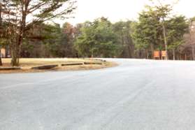 At the top of the hill a road intersects from the left. Continue along that road as it turns to the left on the other side of the field.